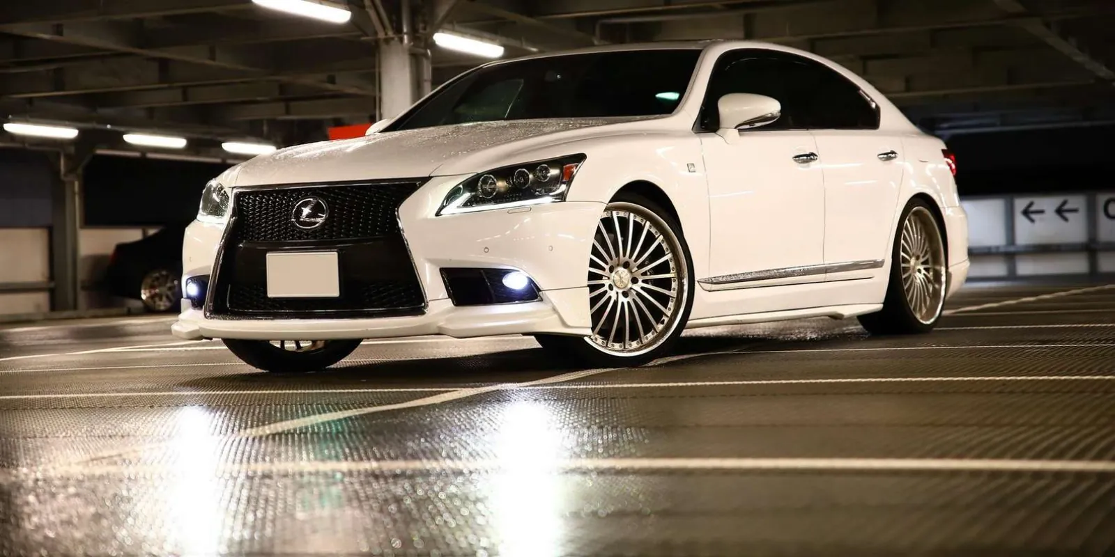 Widebody Lexus LS sedan on deep-dish wheels inside a parking structure